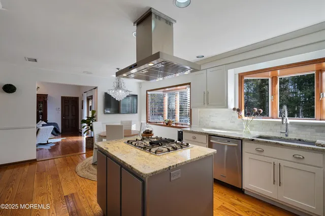 a kitchen with a sink a refrigerator a stove and cabinets