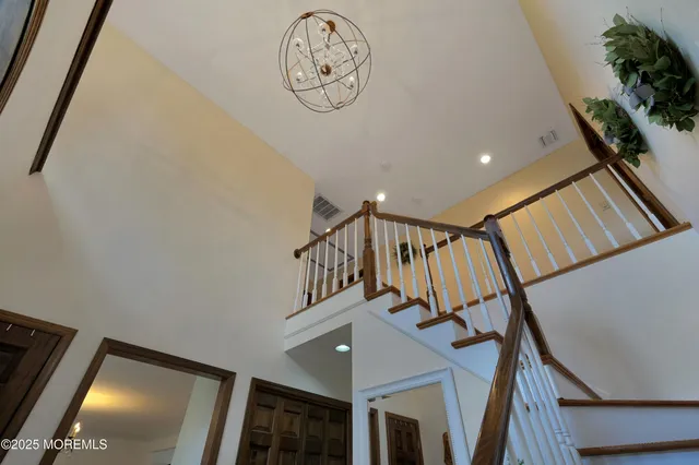 a bathroom with a sink a large mirror and a bathtub next to a window