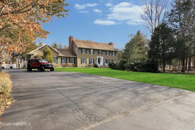 a view of house with yard and green space