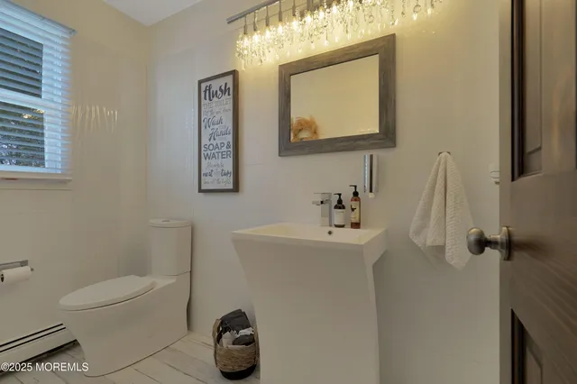 a bathroom with a bathtub sink and mirror