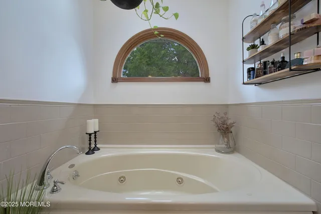 a view of a house with a yard and large tree