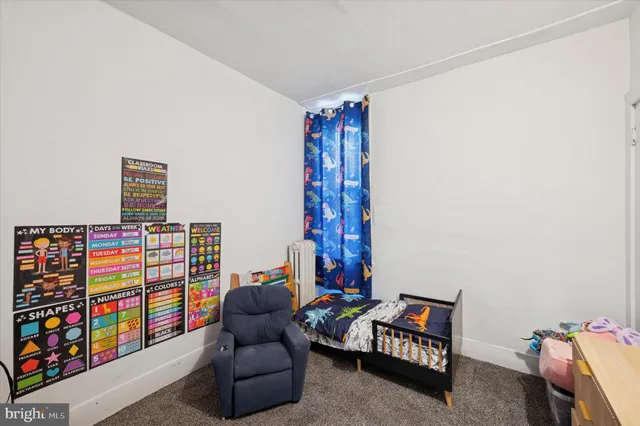 a living room with furniture and a book shelf