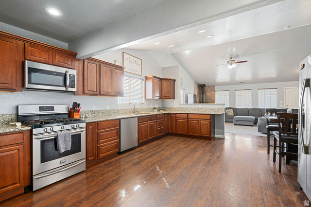 348 North Lodge Road Central, UT 84722 - Photo 25 of 25 Kitchen featuring stainless steel appliances, a peninsula, open floor plan, wood finish cabinetry, and dark wood-type flooring