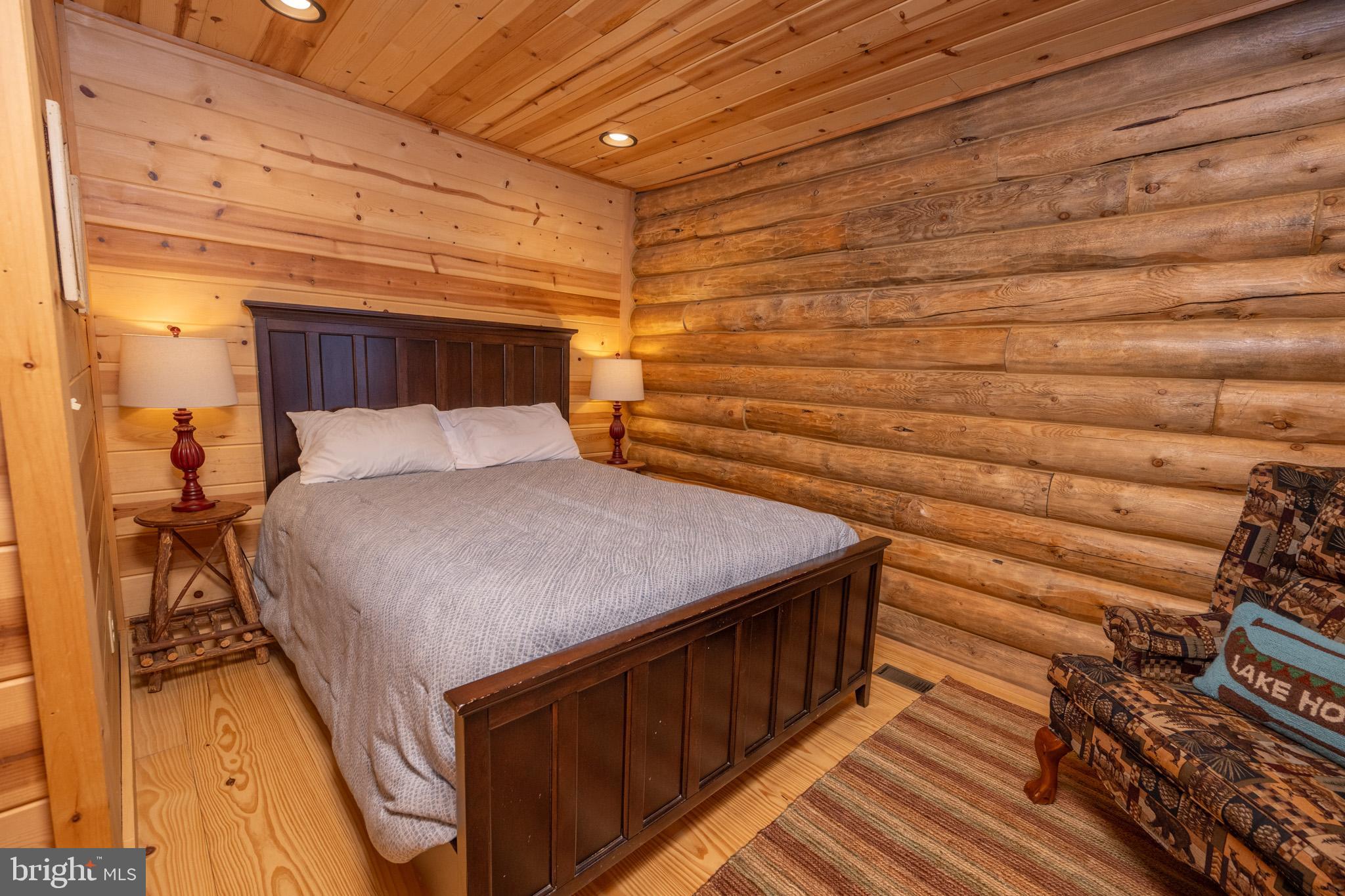 88 Gravelly Run Road McHenry, MD 21541 - Photo 30 of 79 a bedroom with a bed and wooden floor