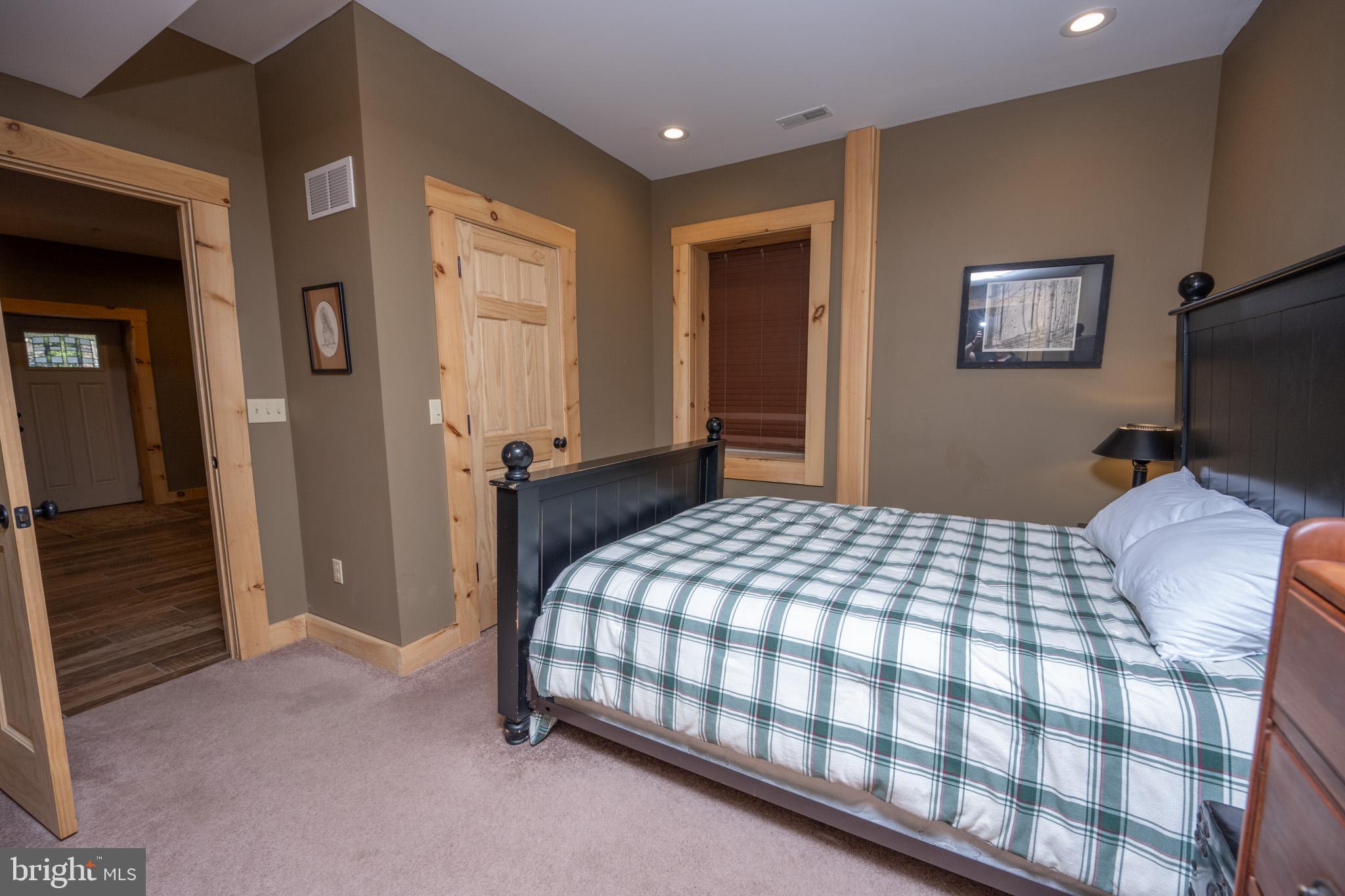 88 Gravelly Run Road McHenry, MD 21541 - Photo 59 of 79 a bedroom with a bed and a flat tv screen on dresser