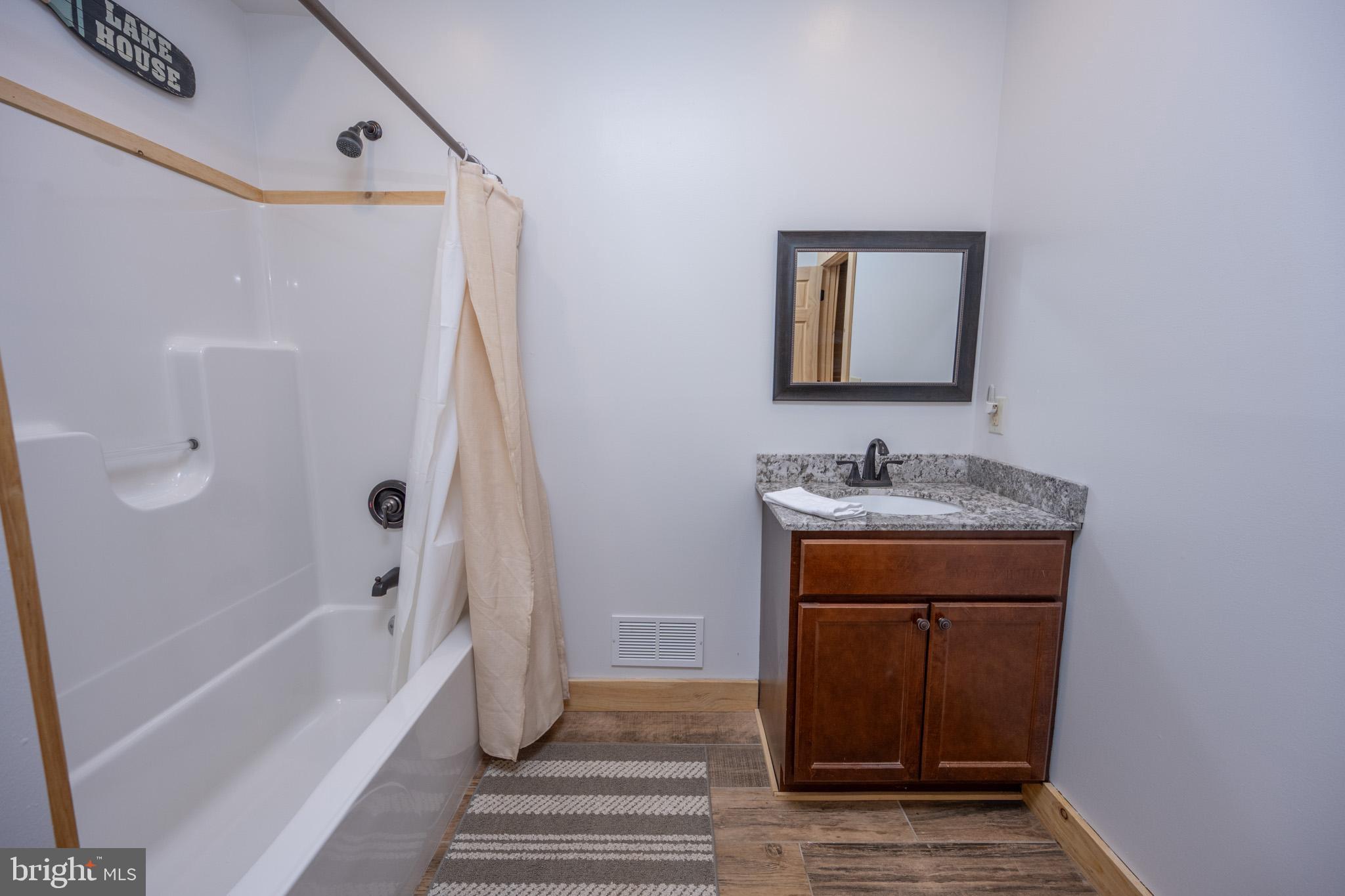 88 Gravelly Run Road McHenry, MD 21541 - Photo 63 of 79 a bathroom with a sink a mirror and a bathtub