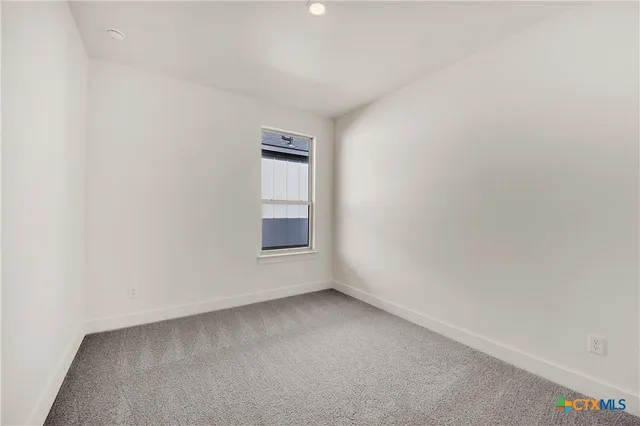 a view of an empty room and a window