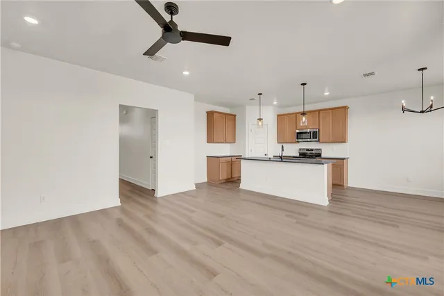 a view of kitchen with microwave and cabinets