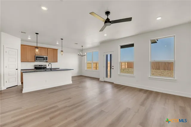 a view of kitchen with sink and wooden floor