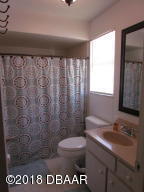 99 Mayfield Circle Ormond Beach, FL 32174 - Photo 14 of 28 a bathroom with a sink a toilet and a mirror