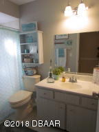 99 Mayfield Circle Ormond Beach, FL 32174 - Photo 16 of 28 a bathroom with a sink a toilet and a mirror