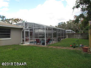 99 Mayfield Circle Ormond Beach, FL 32174 - Photo 24 of 28 a view of a house with backyard sitting area and garden