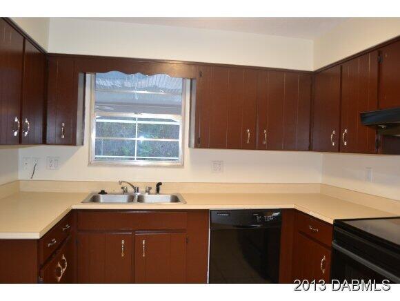 99 Mayfield Circle Ormond Beach, FL 32174 - Photo 3 of 28 a bathroom with a sink vanity and mirror