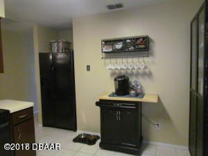 99 Mayfield Circle Ormond Beach, FL 32174 - Photo 6 of 28 a kitchen with a stove and a refrigerator