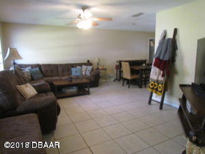 99 Mayfield Circle Ormond Beach, FL 32174 - Photo 10 of 28 a living room with furniture and a flat screen tv