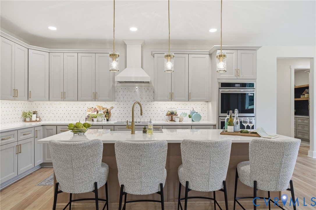 67 Hicks Wharf Road Cardinal, VA 23025 - Photo 13 of 50 a kitchen with stainless steel appliances kitchen island granite countertop a dining table chairs and white cabinets