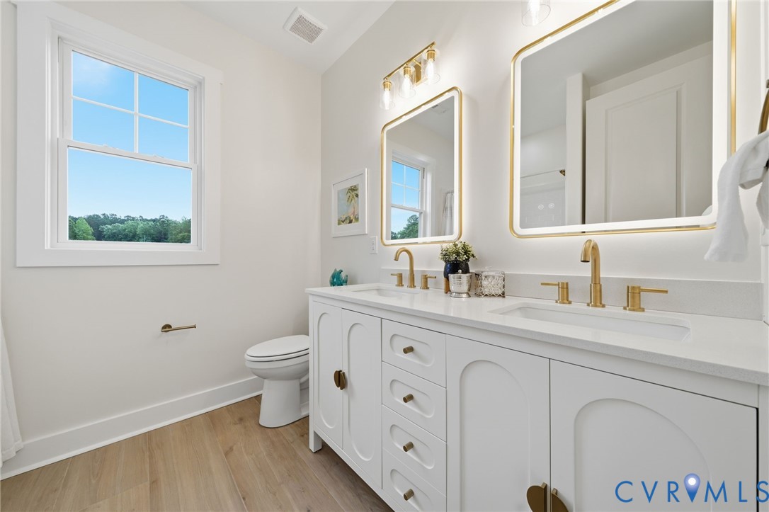 67 Hicks Wharf Road Cardinal, VA 23025 - Photo 28 of 50 a bathroom with a granite countertop toilet sink and mirror