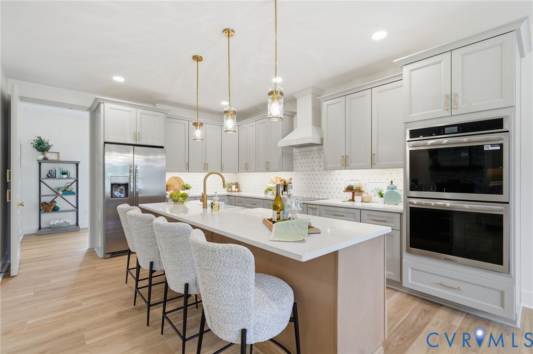 67 Hicks Wharf Road Cardinal, VA 23025 - Photo 8 of 50 a kitchen with a dining table chairs stainless steel appliances and cabinets