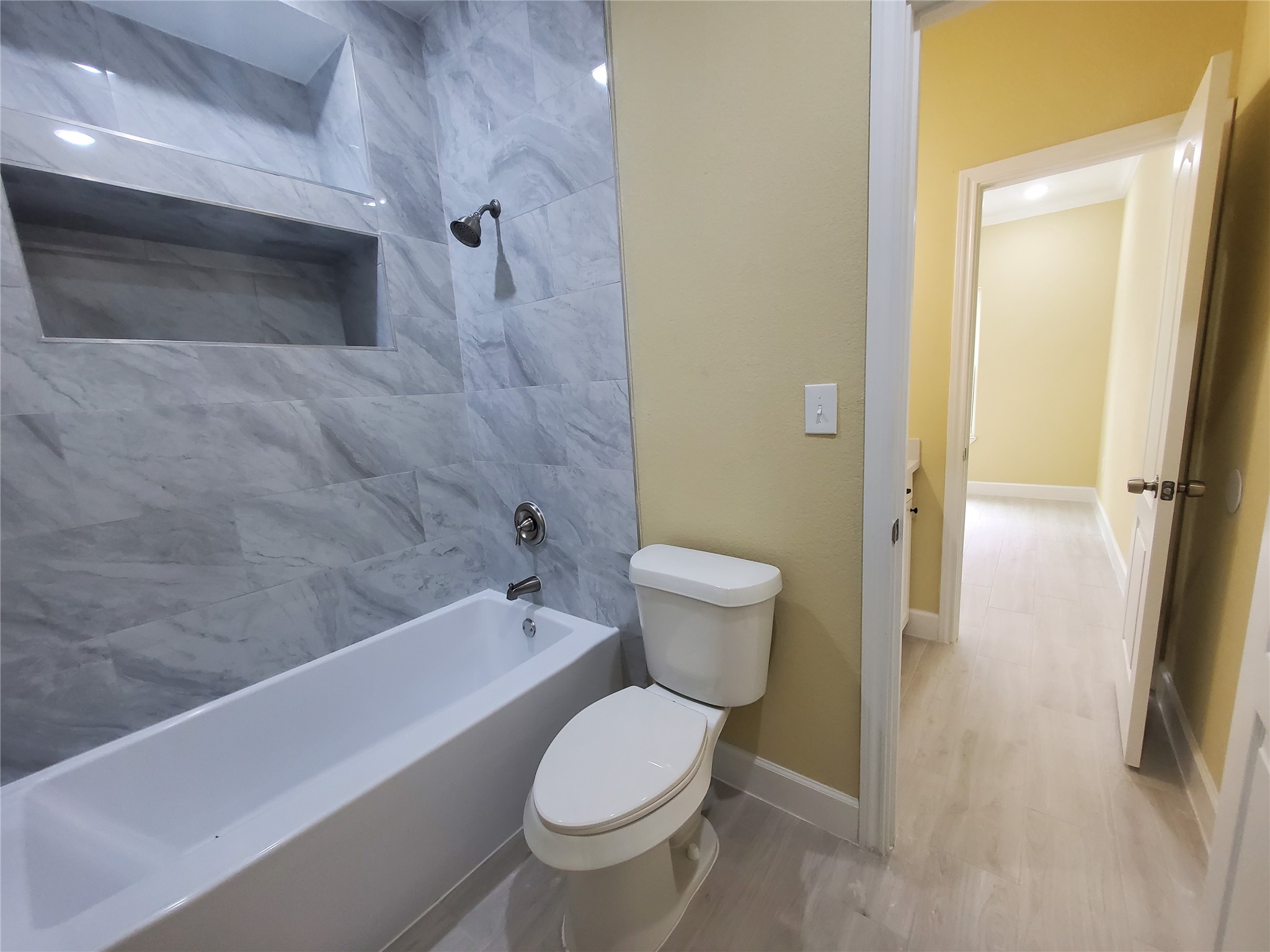 1306 North 9th Street Conroe, TX 77301 - Photo 38 of 47 a bathroom with a toilet and a shower
