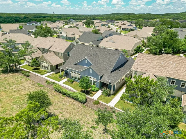 an aerial view of a house with a big yard