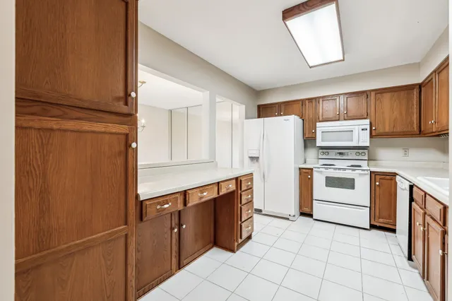 a kitchen with white cabinets and white appliances