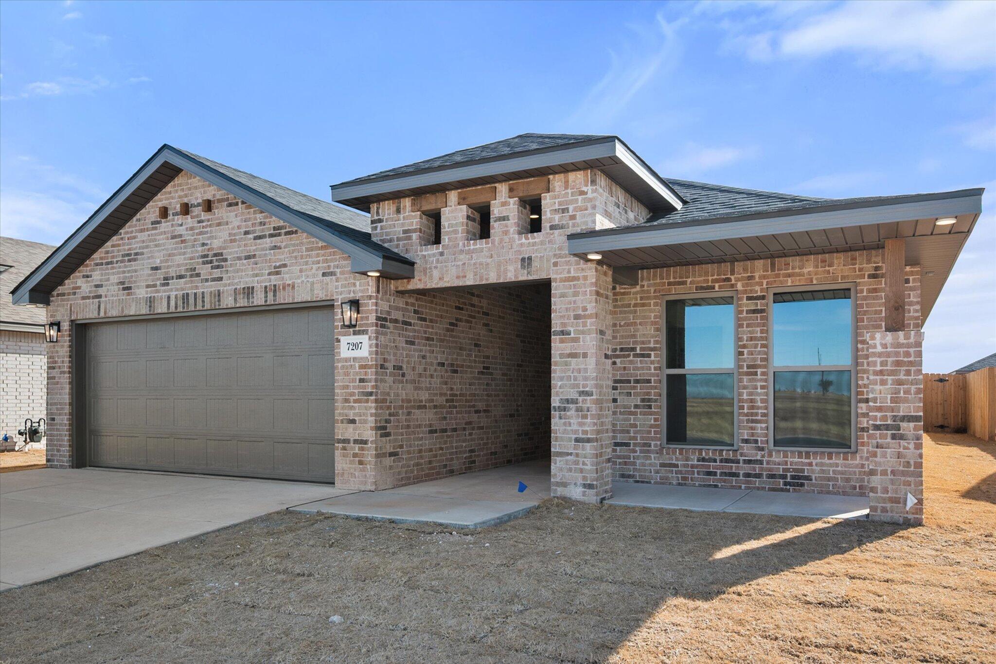 7207 7th Street Lubbock, TX 79416 - Photo 1 of 22 a front view of a house with a garage