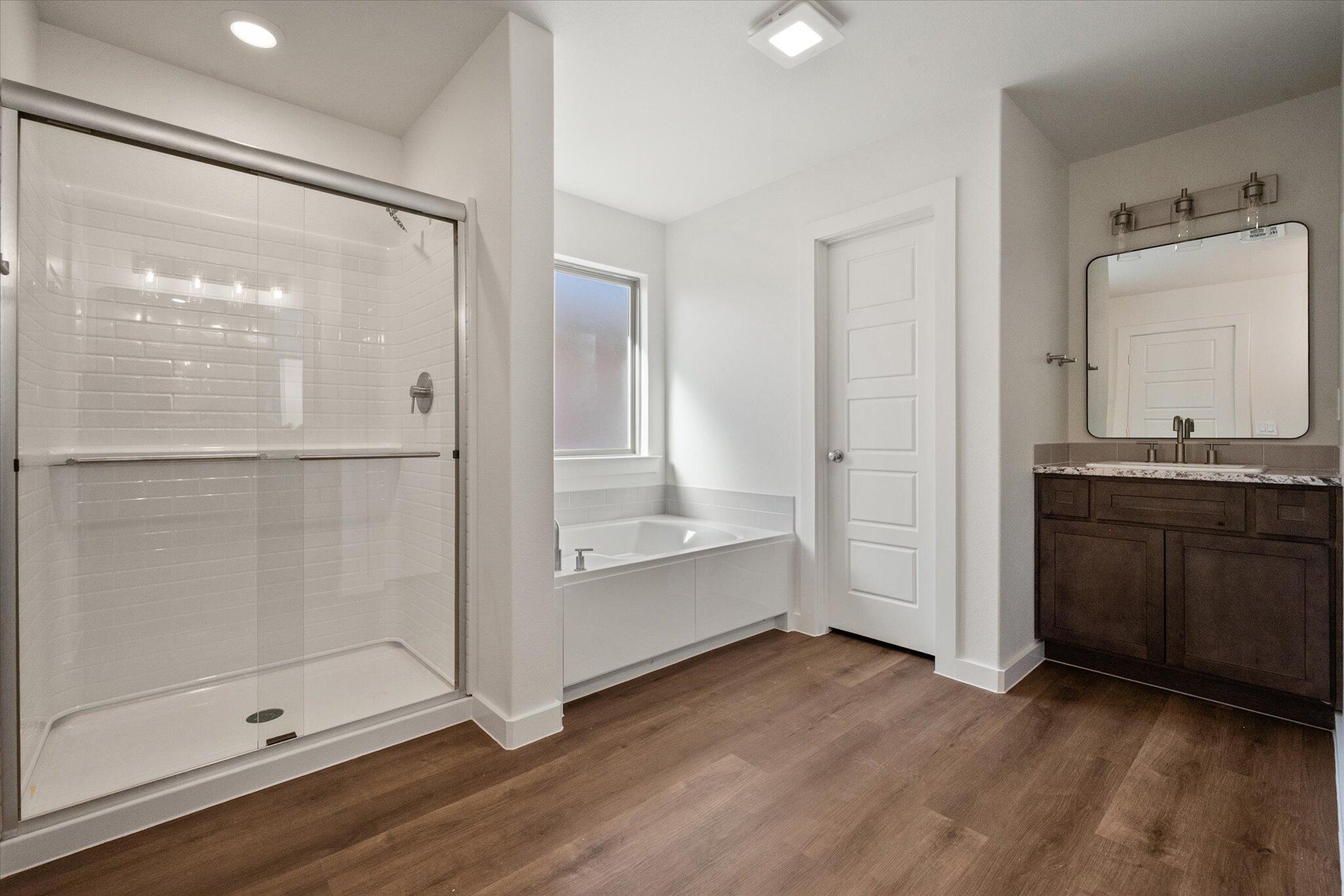 7207 7th Street Lubbock, TX 79416 - Photo 13 of 22 a bathroom with a glass shower door and a sink