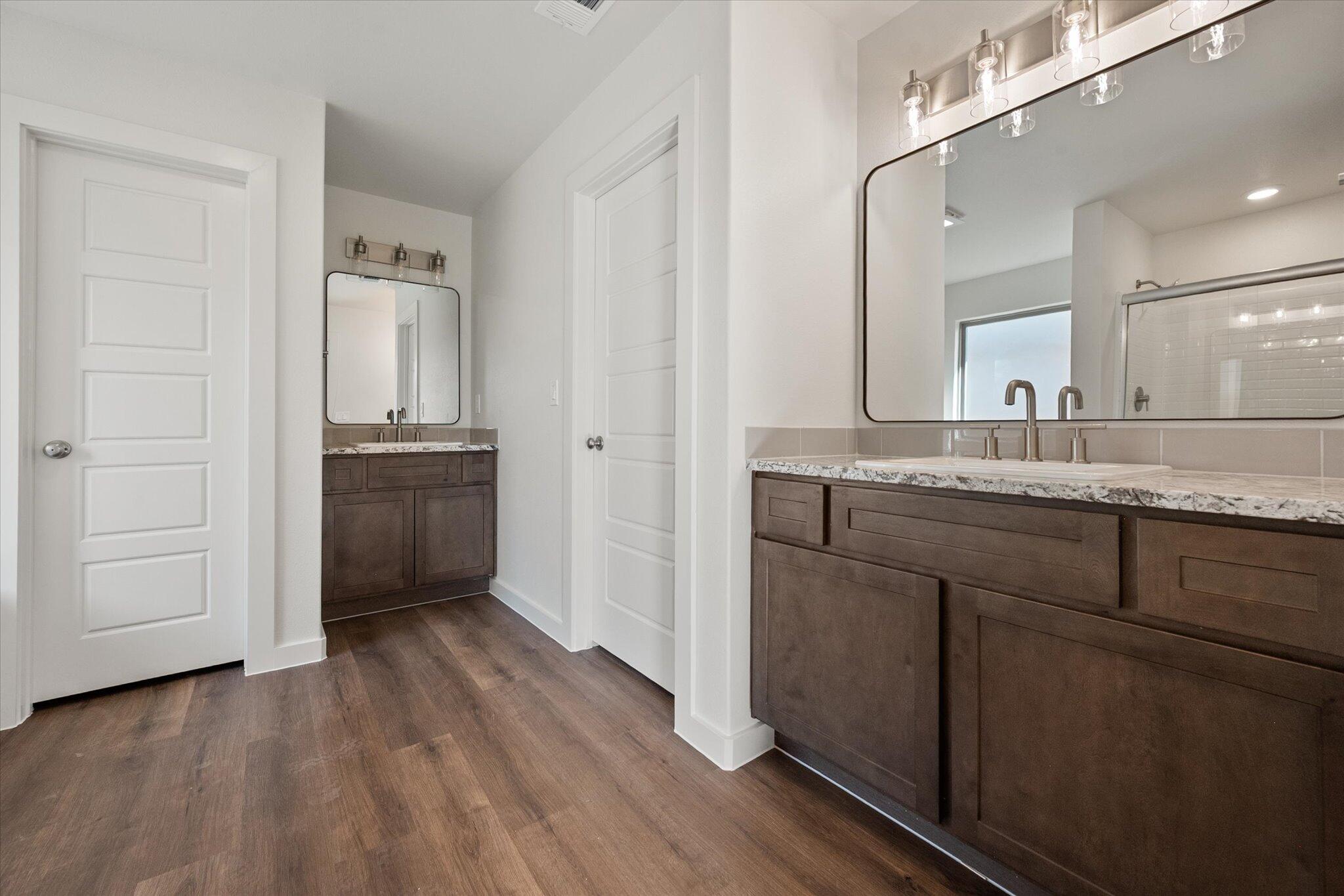 7207 7th Street Lubbock, TX 79416 - Photo 17 of 22 a bathroom with a granite countertop sink and mirror