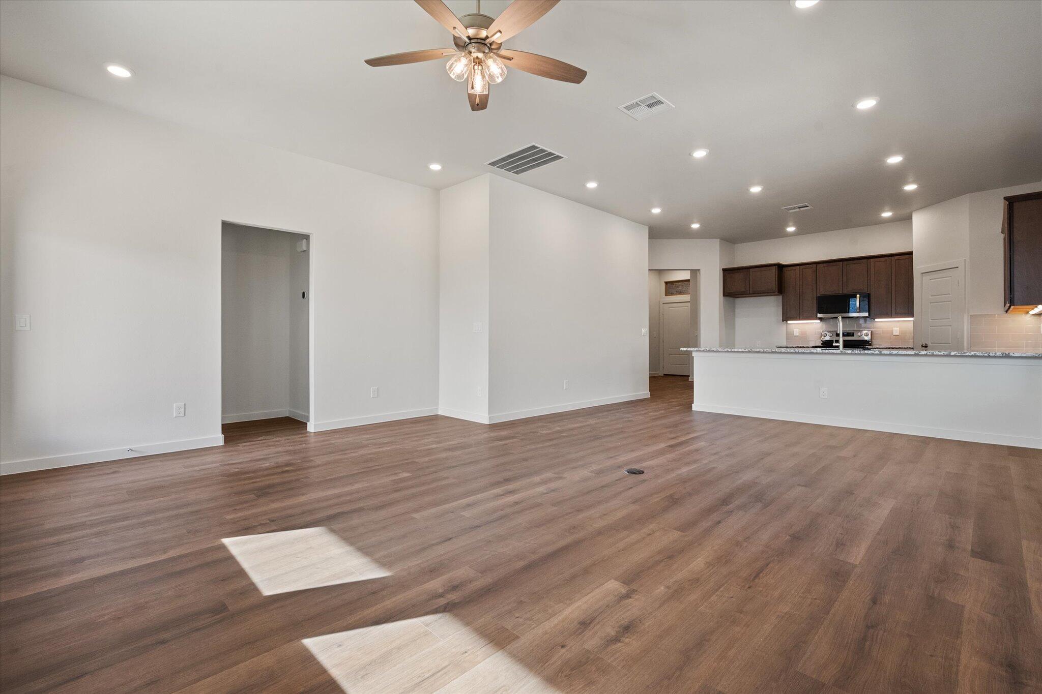 7207 7th Street Lubbock, TX 79416 - Photo 9 of 22 a view of a kitchen with a sink and a refrigerator