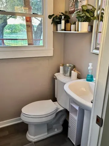 a white toilet sitting next to a bathroom sink