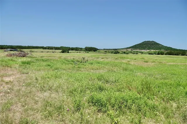 a view of an mountain and a yard