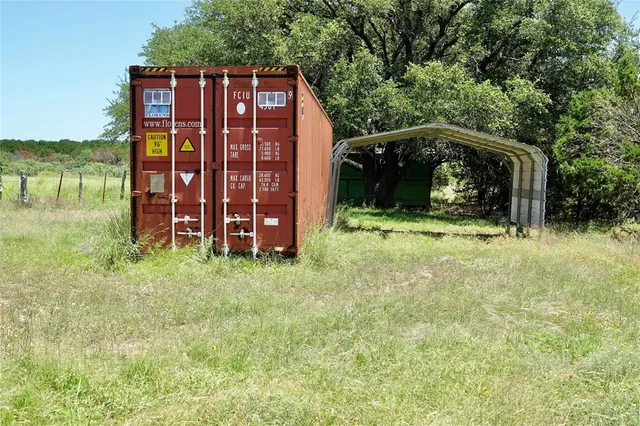 a view of a back yard of the house with a yard