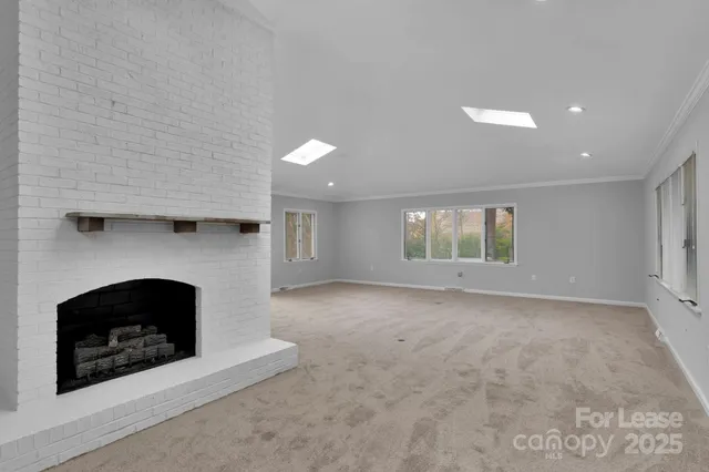 a view of an empty room with a fireplace