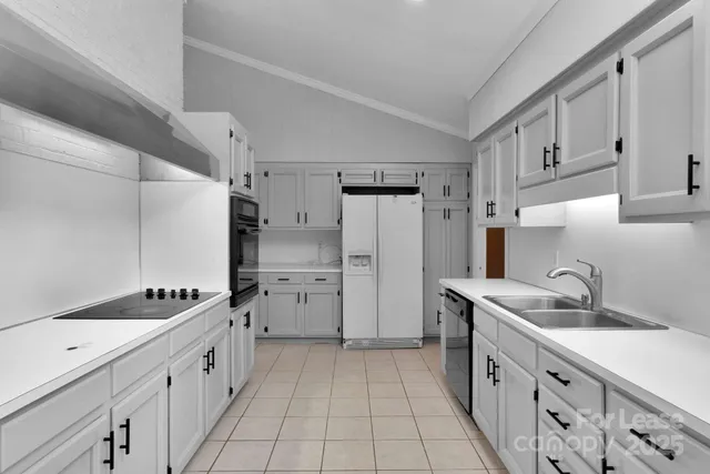 a kitchen with a sink stove and refrigerator