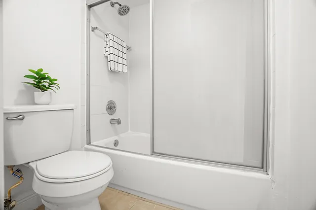 a bathroom with a toilet and a shower
