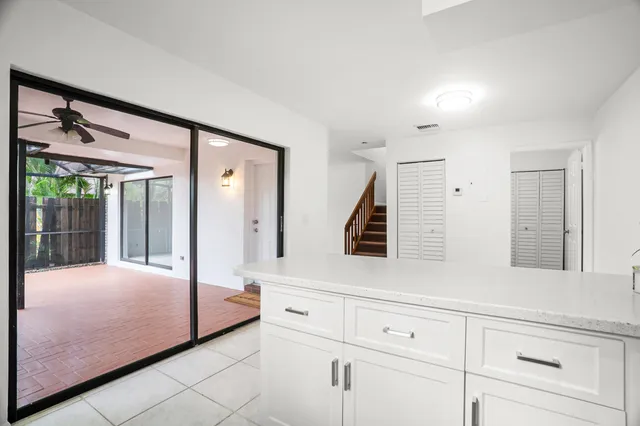 a bedroom with a bed a mirror and window