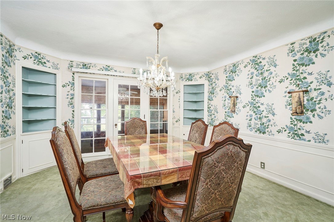 3676 Rawnsdale Road Beachwood, OH 44122 - Photo 7 of 20 Carpeted dining room featuring wainscoting, suspended lighting, wallpapered walls, and built in features