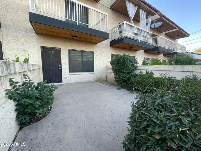 a view of a house with potted plants