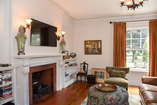 a living room with furniture a flat screen tv and a fireplace