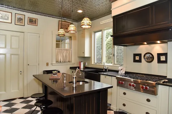 a kitchen that has a sink and a stove in it