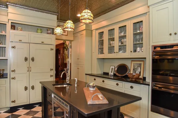 a kitchen with a stove a refrigerator and a dining table