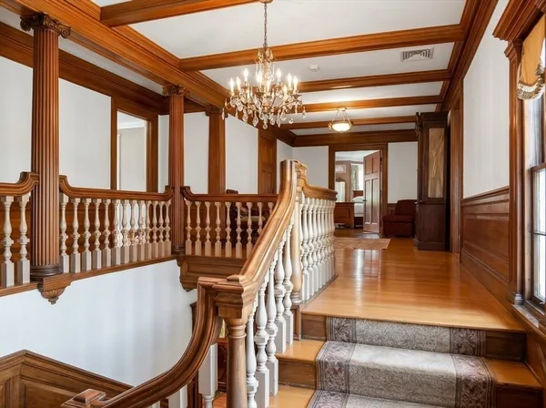 a view of a living room and chandelier