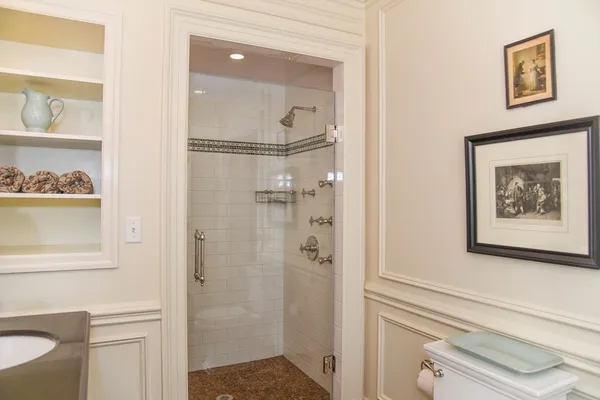 a bathroom with a shower and a mirror