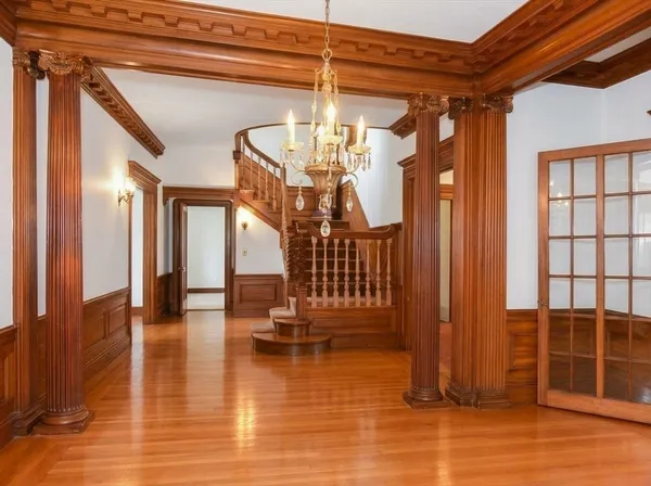 a view of a livingroom with wooden floor and stairs