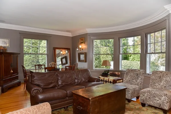 a living room with furniture and large windows