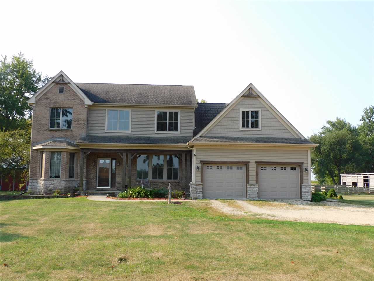 3265 Bloods Point Road Kirkland, IL 60146 - Photo 1 of 35 a front view of a house with a garden