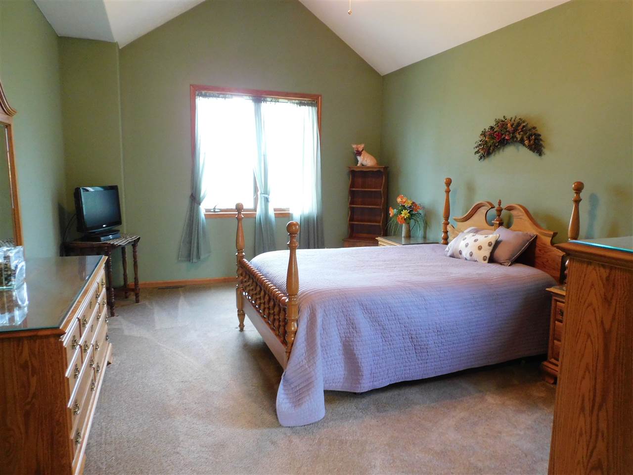 3265 Bloods Point Road Kirkland, IL 60146 - Photo 12 of 35 a bedroom with a bed and a flat tv screen on the dresser