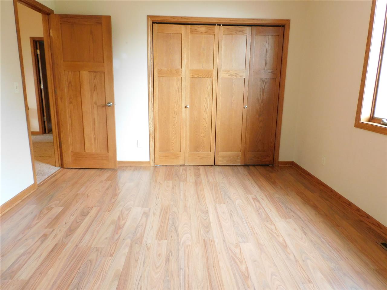 3265 Bloods Point Road Kirkland, IL 60146 - Photo 20 of 35 an empty room with wooden floor and windows