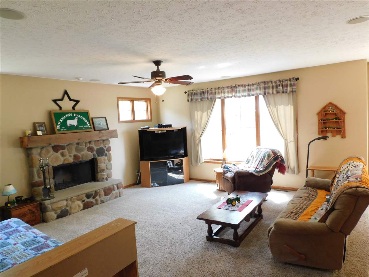 3265 Bloods Point Road Kirkland, IL 60146 - Photo 3 of 35 a living room with furniture a fireplace and a flat screen tv