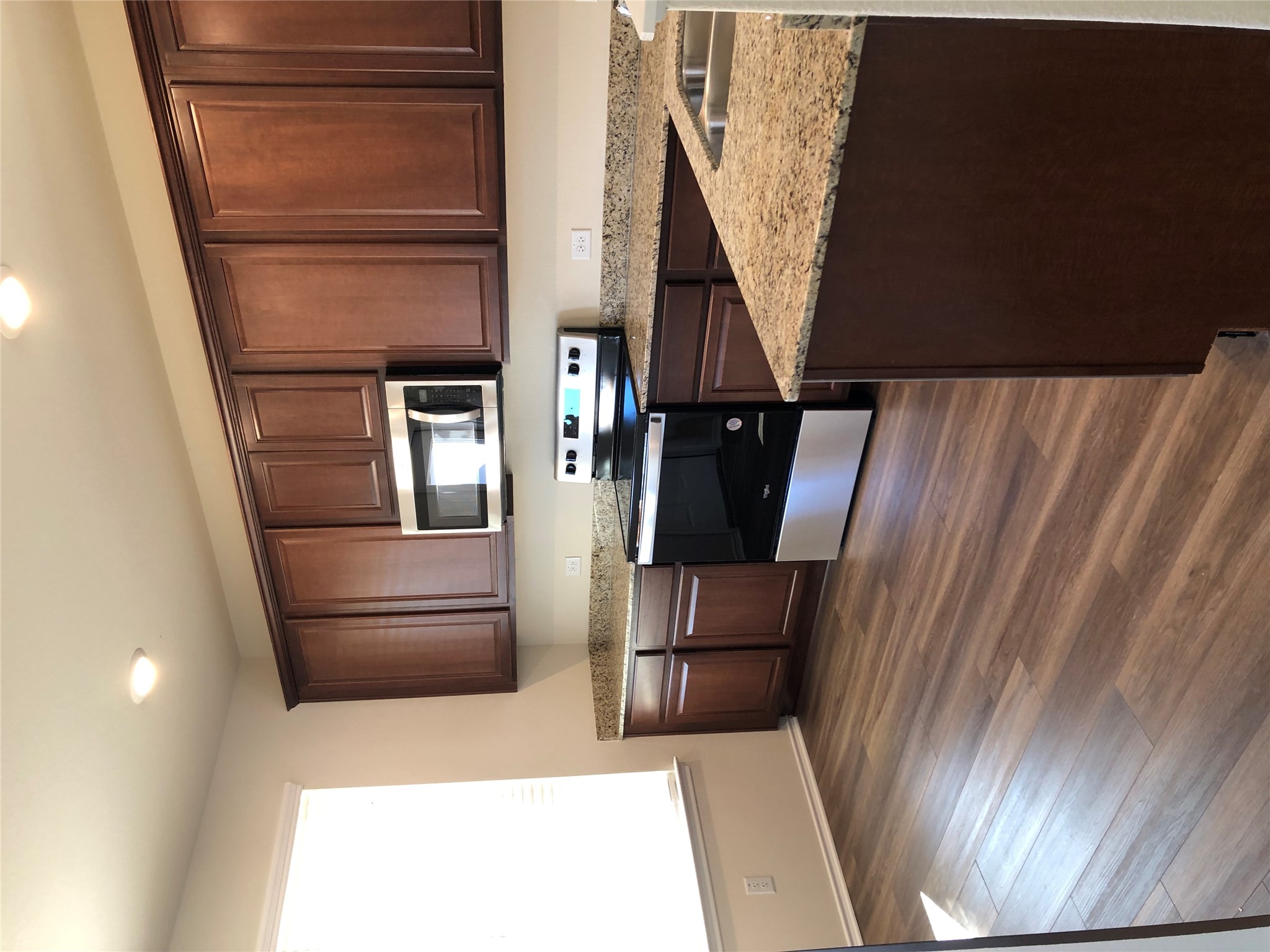 130 Lt Rusty Drive Jarrell, TX 76537 - Photo 4 of 13 A well-appointed kitchen features rich cabinetry, granite countertops, and modern appliances.